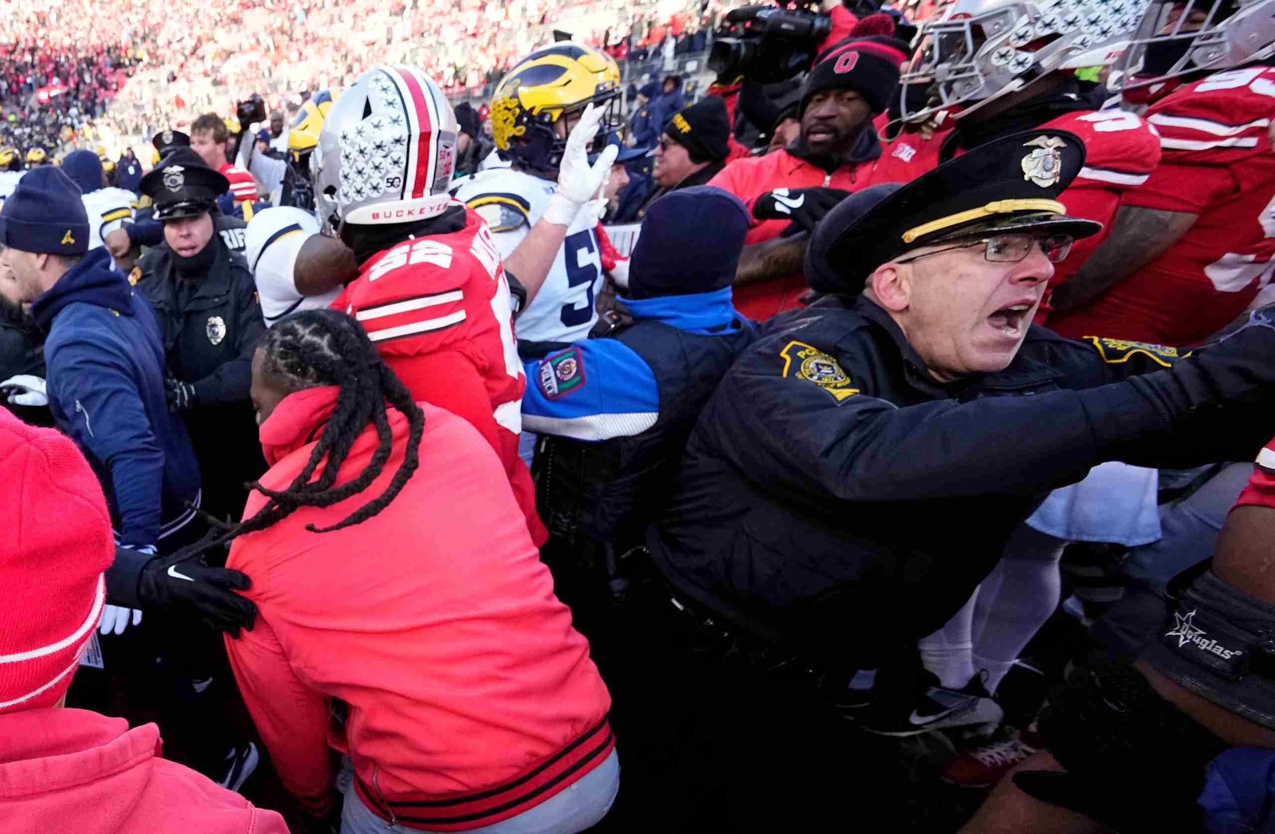 University of Michigan and Ohio State Police intervene as Michigan Wolverines and Ohio State Buckeyes fight following the NCAA football game at Ohio Stadium in Columbus on Saturday, Nov. 30, 2024. Michigan won 13-10.